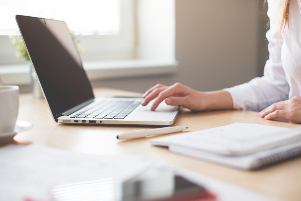 Women working on brand guidelines on her laptop.