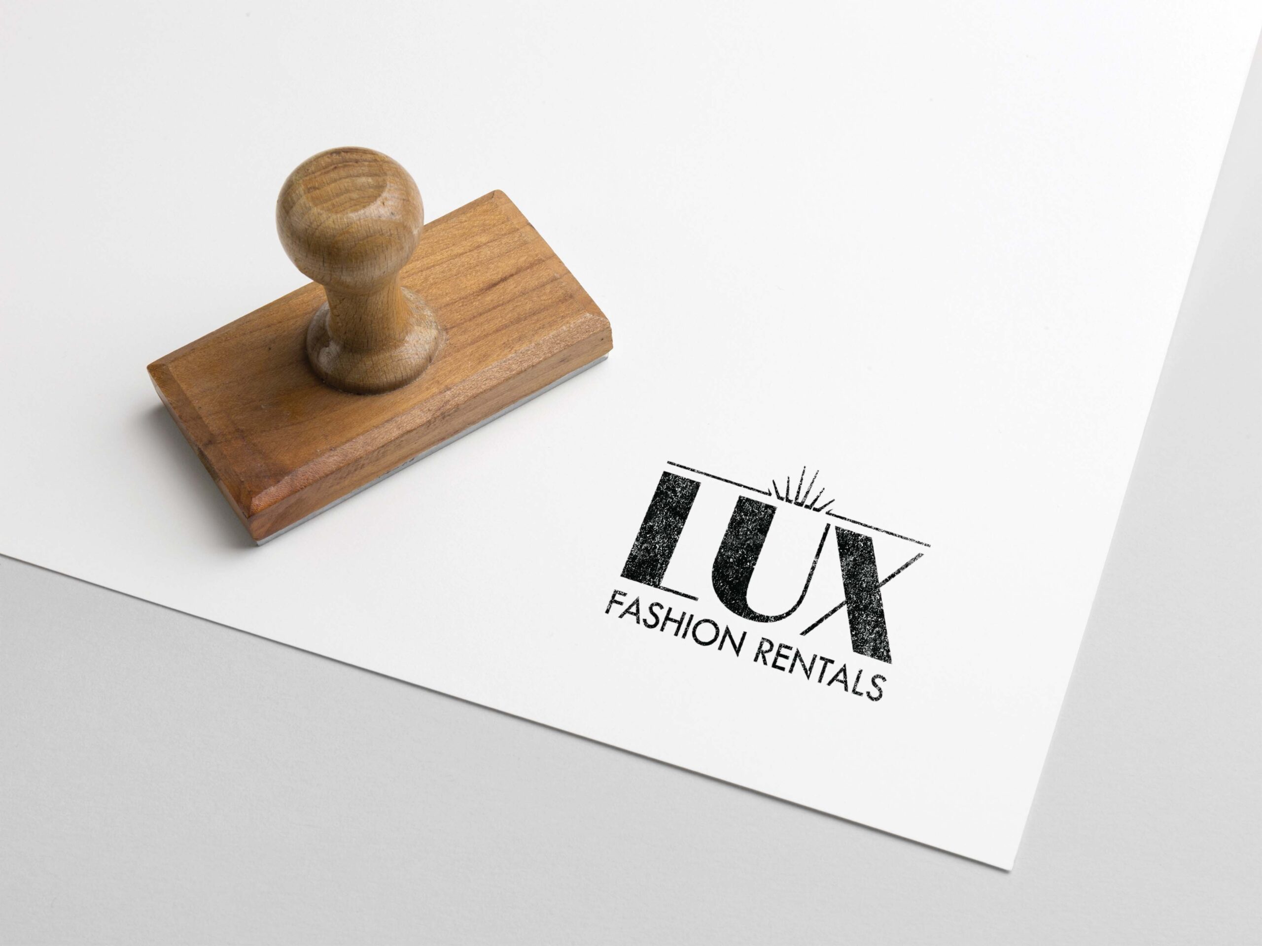 Rubber Stamped image of the LUX Fashion Rentals Logo